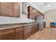Modern kitchen featuring wood cabinets, granite countertops, stainless steel appliances, and tile backsplash at 12784 Burns Dr, Odessa, FL 33556