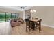 Open-concept area featuring a living room, dining space, and large windows with outdoor views at 12784 Burns Dr, Odessa, FL 33556