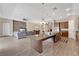Open-concept living space featuring a large island, granite countertops, and a comfortable living area with a stone accent wall at 12784 Burns Dr, Odessa, FL 33556