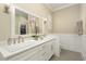 Elegant bathroom showcasing double sinks, marble countertops, and modern fixtures at 1751 Bobcat Trl, North Port, FL 34288