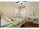 This is a well-lit bedroom with plantation shutters, a ceiling fan, and a desk at 1751 Bobcat Trl, North Port, FL 34288