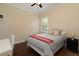 Well-lit bedroom with hardwood floors, plantation shutters, and comfortable furnishings at 1751 Bobcat Trl, North Port, FL 34288
