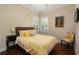Cozy bedroom featuring plantation shutters, a comfortable bed, and stylish decor at 1751 Bobcat Trl, North Port, FL 34288