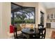 Inviting breakfast nook with a built-in bench, comfortable seating, and views of the outdoor pool area at 1751 Bobcat Trl, North Port, FL 34288