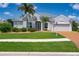Beautiful single-story home featuring a well-maintained lawn, lush landscaping, and a two-car garage at 1751 Bobcat Trl, North Port, FL 34288