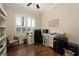Bright home office with a large window, plantation shutters, custom desk, and hardwood flooring at 1751 Bobcat Trl, North Port, FL 34288