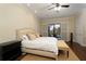 Comfortable main bedroom with access to the patio, featuring ample natural light and hardwood floors at 1751 Bobcat Trl, North Port, FL 34288