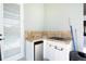 An outdoor kitchen with a grill, sink, refrigerator, and a door leading to the pool at 1751 Bobcat Trl, North Port, FL 34288