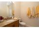 Inviting powder room with granite countertops, decorative fixtures, and a warm color palette at 1751 Bobcat Trl, North Port, FL 34288