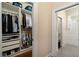Organized walk-in closet with custom shelving and ample storage space, leading to the bathroom at 1751 Bobcat Trl, North Port, FL 34288