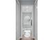Well-lit bathroom has marble flooring, a bright arched window and white cabinets at 3244 55Th Ave N, St Petersburg, FL 33714