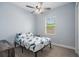 Bedroom features a ceiling fan and a window providing natural light at 3244 55Th Ave N, St Petersburg, FL 33714