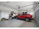 Clean garage featuring epoxy flooring, ample storage, and a modern vehicle; well organized at 3244 55Th Ave N, St Petersburg, FL 33714