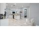 Open-concept kitchen with an island and marble floors leading to the living area at 3244 55Th Ave N, St Petersburg, FL 33714