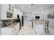 Spacious kitchen featuring white cabinets, granite countertops, stainless steel appliances, and a center island at 3244 55Th Ave N, St Petersburg, FL 33714