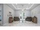 Bright living room with marble floors, recessed lighting, ceiling fan, and patio doors leading to the lanai at 3244 55Th Ave N, St Petersburg, FL 33714