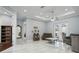 Sunlit living room with marble floors, recessed lighting, patio doors, and a ceiling fan above at 3244 55Th Ave N, St Petersburg, FL 33714