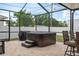 Relaxing screened patio featuring a spa, grill, and brick pavers for stylish outdoor living at 3244 55Th Ave N, St Petersburg, FL 33714