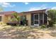 Backyard area with a screened porch, mature plants, and potential for outdoor enjoyment at 4549 Tippecanoe Trl # 20, Sarasota, FL 34233
