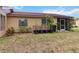 Backyard view featuring the exterior with a cozy screened-in porch and garden potential at 4549 Tippecanoe Trl # 20, Sarasota, FL 34233