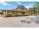 Single story building with a brown roof, light beige exterior and professional landscaping at 4549 Tippecanoe Trl # 20, Sarasota, FL 34233