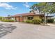 The exterior of this one-story building features lush green landscaping and a well-maintained parking area at 4549 Tippecanoe Trl # 20, Sarasota, FL 34233