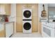 Modern kitchen with stacked washer/dryer, stainless appliances, and sleek cabinetry at 4549 Tippecanoe Trl # 20, Sarasota, FL 34233