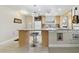 Bright kitchen features stone counters with seating, wine rack and stainless steel appliances at 4549 Tippecanoe Trl # 20, Sarasota, FL 34233