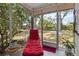 Enclosed outdoor patio with lounge chair and views of landscaped backyard at 4549 Tippecanoe Trl # 20, Sarasota, FL 34233