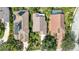 Birds eye view of a home with a tile roof, lush landscaping, and well-manicured lawns at 6504 Virginia Xing, University Park, FL 34201
