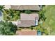 Aerial view of a single-Gathering home featuring a tile roof, manicured landscaping, and a spacious backyard at 6504 Virginia Xing, University Park, FL 34201