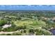 Wide aerial shot of a sprawling golf course community with multiple greens, water features, and residential areas at 6504 Virginia Xing, University Park, FL 34201