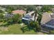 An aerial view of the backyard featuring lush landscaping, lawn, and screened lanai at 6504 Virginia Xing, University Park, FL 34201