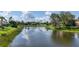 A serene pond view with lush landscaping and serene water views in the backyard at 6504 Virginia Xing, University Park, FL 34201