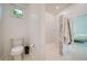 Modern bathroom with a toilet, white-tiled shower, and marble accents, offering a clean and stylish design at 6504 Virginia Xing, University Park, FL 34201