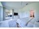 Bright, spacious bedroom featuring clean design, white tile flooring, and sliding door access to the backyard at 6504 Virginia Xing, University Park, FL 34201