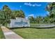 The University Park Country Club entrance with manicured landscaping, and a clear, bright blue sky at 6504 Virginia Xing, University Park, FL 34201