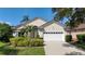 Attractive single-Gathering home boasts manicured landscaping, a spacious two-car garage, and a welcoming facade at 6504 Virginia Xing, University Park, FL 34201
