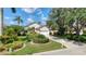 Charming single-Gathering home featuring lush landscaping, a well-manicured lawn, and a two-car garage at 6504 Virginia Xing, University Park, FL 34201