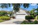 Close up view of a well-kept single-Gathering home with a spacious two-car garage and manicured landscaping at 6504 Virginia Xing, University Park, FL 34201