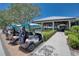 Community golf carts parked near the clubhouse, ready for a sunny round of golf at 6504 Virginia Xing, University Park, FL 34201