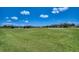 Expansive green golf course with a scenic view of a lake and blue sky at 6504 Virginia Xing, University Park, FL 34201