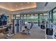 Well-equipped gym area with weight machines and ample natural light from large windows at 6504 Virginia Xing, University Park, FL 34201