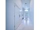 Bright hallway leading to the front door, featuring stylish tile flooring and ample natural light at 6504 Virginia Xing, University Park, FL 34201