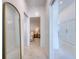 Hallway featuring tiled floors and a gold mirror, leading to the bedroom in the background at 6504 Virginia Xing, University Park, FL 34201