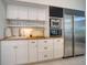 Bright kitchen with white cabinets, stainless steel appliances, wood countertops, and modern fixtures at 6504 Virginia Xing, University Park, FL 34201