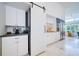 Kitchen featuring white cabinets, stainless steel appliances, and an adjacent breakfast nook at 6504 Virginia Xing, University Park, FL 34201