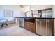 Kitchen with stainless steel appliances, black countertops, farmhouse sink, and bright white walls at 6504 Virginia Xing, University Park, FL 34201