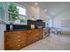 Kitchen featuring wood cabinets, stainless steel appliances, granite countertops, and a window with a view at 6504 Virginia Xing, University Park, FL 34201