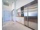 Bright kitchen with white cabinets, stainless steel appliances, a sliding barn door, and tile floors at 6504 Virginia Xing, University Park, FL 34201